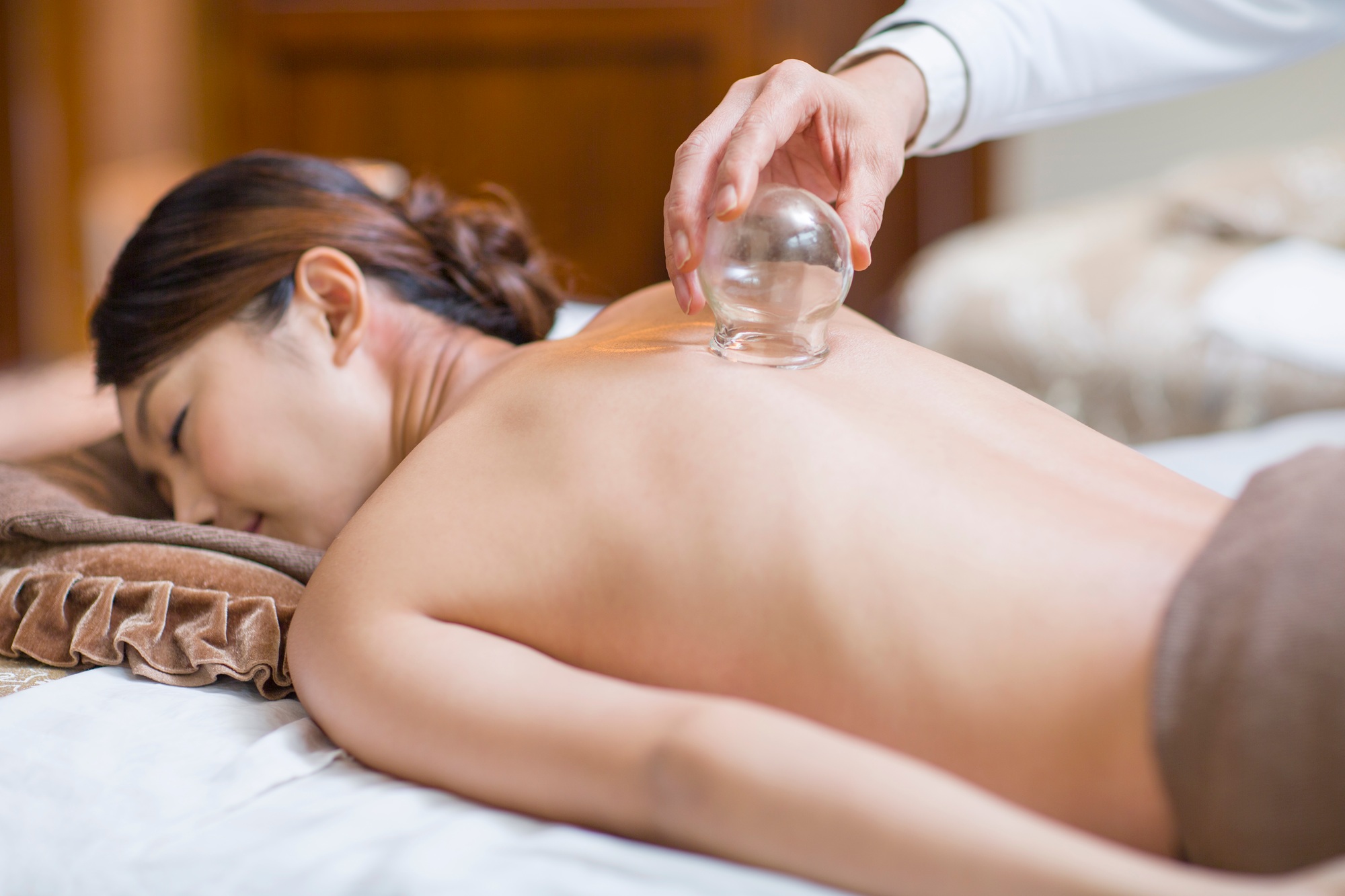 Young woman receiving vacuum cupping treatment